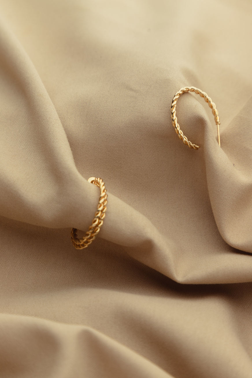 Gold Earrings on Brown Satin Cloth